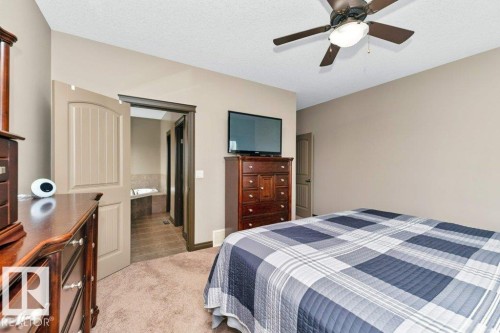 The bedroom features neutral-toned walls, plush carpet flooring, and a ceiling fan - 33 Hillcrest Point(E), Fort Saskatchewan, AB - Indoor Photo Showing Bedroom