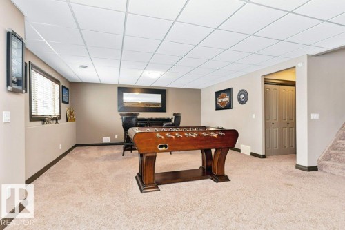 Spacious room featuring carpeting, neutral-toned walls, and a drop ceiling with recessed lighting - 33 Hillcrest Point(E), Fort Saskatchewan, AB - Indoor Photo Showing Other Room