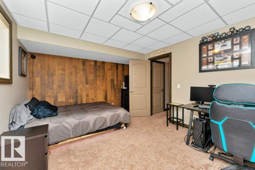This room features carpeted flooring, a ceiling with recessed lighting, and a wall finished with wood paneling - 33 Hillcrest Point(E), Fort Saskatchewan, AB - Indoor
