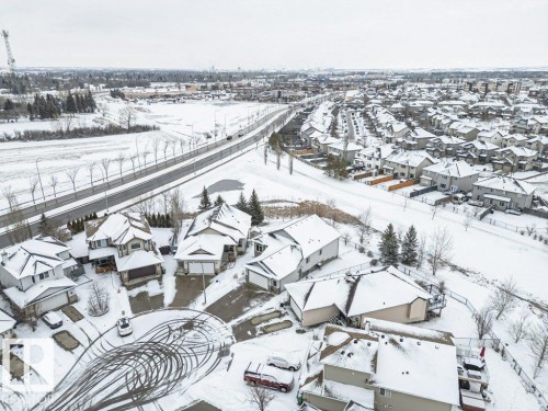 Aerial view of the residential area, featuring houses with snow-covered roofs and surrounding grounds - 33 Hillcrest Point(E), Fort Saskatchewan, AB - Outdoor With View