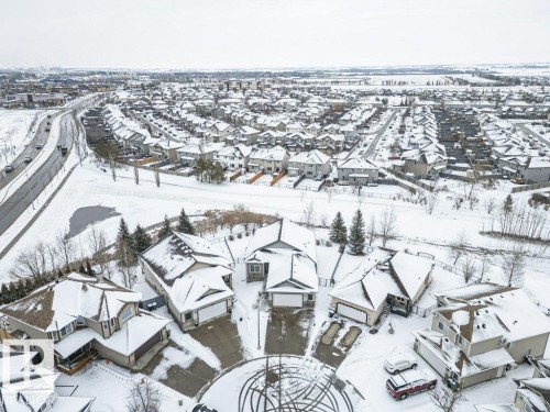 Aerial view of the neighborhood showcasing homes with snow-covered roofs and surrounding natural areas - 33 Hillcrest Point(E), Fort Saskatchewan, AB - Outdoor With View