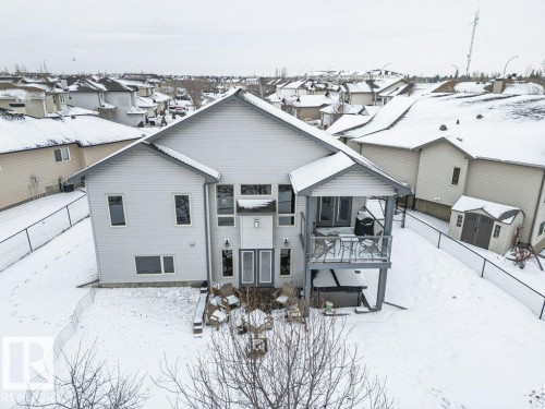 The property features a multi-level deck with outdoor seating, a covered patio area, and a lower-level patio with additional seating - 33 Hillcrest Point(E), Fort Saskatchewan, AB - Outdoor