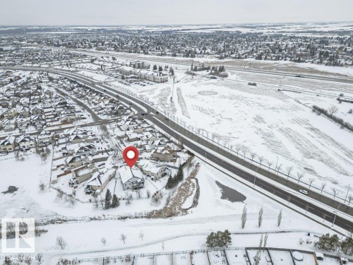 Aerial view of the property and its surrounding residential area, featuring snow-covered rooftops and roads - 33 Hillcrest Point(E), Fort Saskatchewan, AB - Outdoor With View