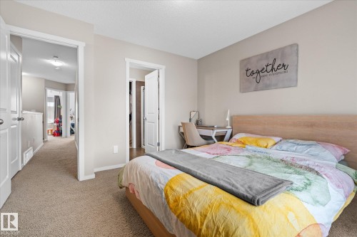 The property features neutral-toned walls, light-colored carpeting, and white trim throughout the interior - 165 603 Watt Boulevard, Edmonton, AB - Indoor Photo Showing Bedroom