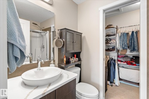 The bathroom features a vessel sink, a chrome faucet, and a shower with a glass enclosure - 165 603 Watt Boulevard, Edmonton, AB - Indoor Photo Showing Bathroom