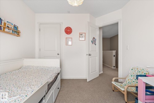 This room features light-colored walls and carpeted flooring - 165 603 Watt Boulevard, Edmonton, AB - Indoor Photo Showing Bedroom