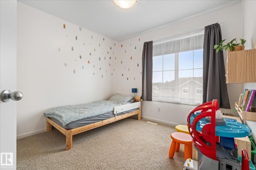 This room features carpeted flooring and white walls, offering a bright and neutral palette - 165 603 Watt Boulevard, Edmonton, AB - Indoor Photo Showing Bedroom