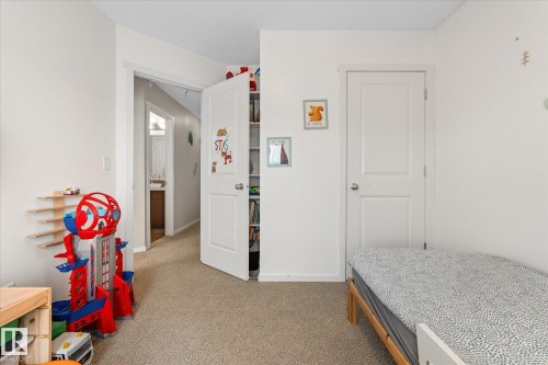 This room features light-colored carpeting, white walls, and white doors - 165 603 Watt Boulevard, Edmonton, AB - Indoor Photo Showing Bedroom