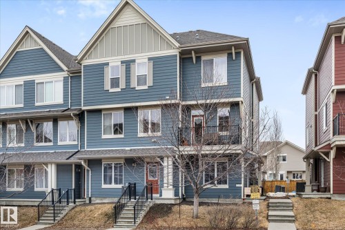 The property features a multi-story exterior with blue siding and white trim - 165 603 Watt Boulevard, Edmonton, AB - Outdoor With Facade