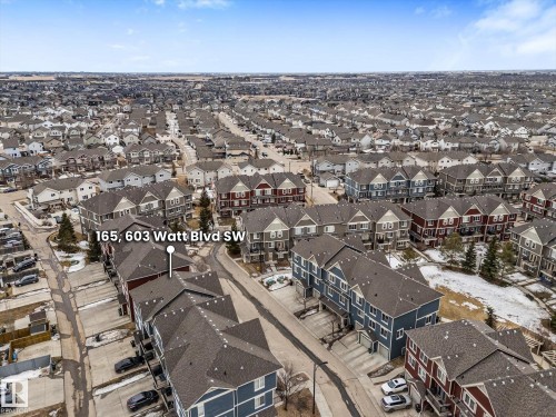 Aerial view showcasing the residential community with rows of attached properties featuring gray roofs - 165 603 Watt Boulevard, Edmonton, AB - Outdoor With View