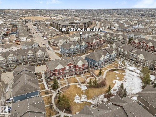 An aerial view of the property, showcasing the surrounding community with a central green space featuring paved walkways and mature trees - 165 603 Watt Boulevard, Edmonton, AB - Outdoor With View