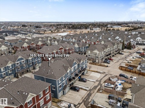 Aerial view of the property and its surrounding residential area, featuring townhomes with various exterior colors and individual driveways - 165 603 Watt Boulevard, Edmonton, AB - Outdoor