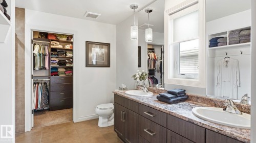 Bathroom featuring dual sinks, a large vanity with cabinets, and a window providing natural light - 131 North Ridge Drive, St. Albert, AB - Indoor Photo Showing Bathroom