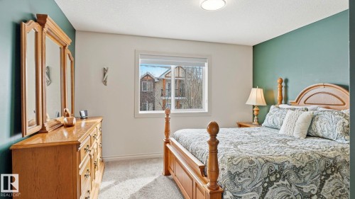 This room features a window providing natural light, carpeted flooring, and a ceiling light fixture - 131 North Ridge Drive, St. Albert, AB - Indoor Photo Showing Bedroom