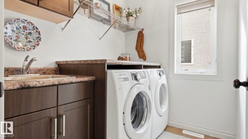 Laundry area featuring a sink with a countertop, cabinetry, and a window providing natural light - 131 North Ridge Drive, St. Albert, AB - Indoor Photo Showing Laundry Room