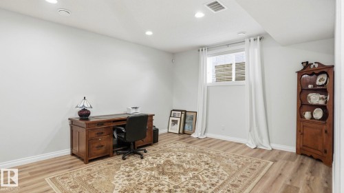 This room features light wood-look flooring, recessed lighting, and a window with white blinds and curtains - 131 North Ridge Drive, St. Albert, AB - Indoor Photo Showing Other Room