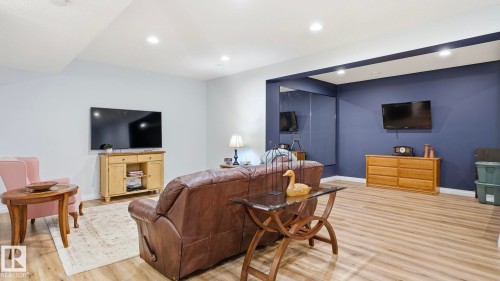 Living area featuring light wood flooring, recessed lighting, and a partial accent wall - 131 North Ridge Drive, St. Albert, AB - Indoor