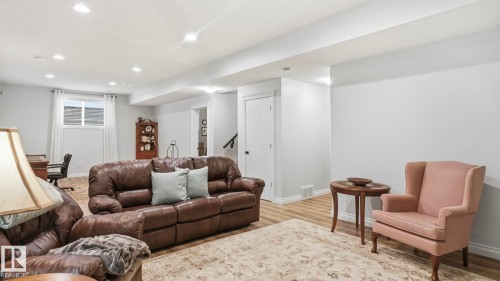 This living area features light-colored walls, recessed lighting, and light wood-style flooring - 131 North Ridge Drive, St. Albert, AB - Indoor