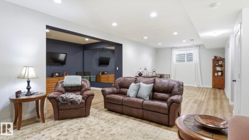 Living area featuring recessed lighting, light wood-style flooring, and a window with white curtains - 131 North Ridge Drive, St. Albert, AB - Indoor