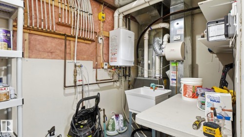 Utility room featuring a furnace, water heater, and a utility sink - 131 North Ridge Drive, St. Albert, AB - Indoor Photo Showing Basement