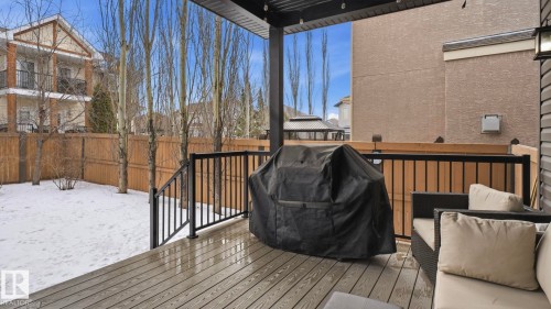 The property features a spacious rear deck with composite decking and black metal railings, overlooking a fenced yard - 131 North Ridge Drive, St. Albert, AB - Outdoor With Deck Patio Veranda With Exterior