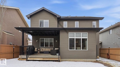 The property features a back exterior with horizontal siding, a covered patio area, and a fenced yard - 131 North Ridge Drive, St. Albert, AB - Outdoor With Exterior