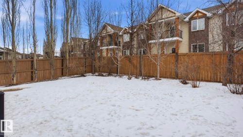 The property features an extensive fenced yard with a clear expanse of snow, offering a blank canvas for future landscaping - 131 North Ridge Drive, St. Albert, AB - Outdoor