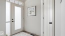 Inviting entryway featuring a white door with frosted glass, a side panel with frosted glass, and a transom window with decorative grilles - 131 North Ridge Drive, St. Albert, AB  - Indoor Photo Showing Other Room 