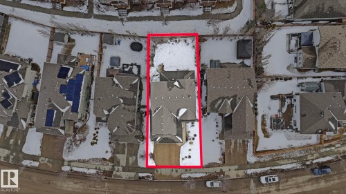 Aerial view of the property, featuring a multi-story home with a gabled roof, a paved driveway, and an extensive yard space - 131 North Ridge Drive, St. Albert, AB - Indoor