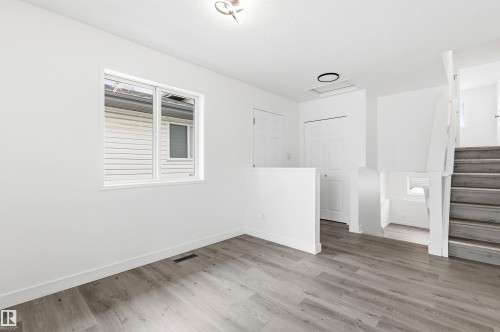 This bright room features light-colored flooring and white walls, creating an open and airy atmosphere - 16223 55A Street, Edmonton, AB - Indoor Photo Showing Other Room