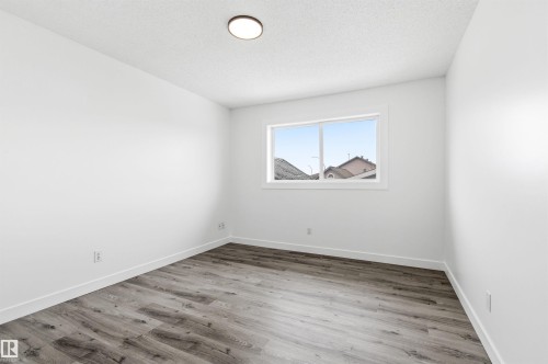 Room with light-toned flooring, white walls, and a window providing natural light - 16223 55A Street, Edmonton, AB - Indoor Photo Showing Other Room