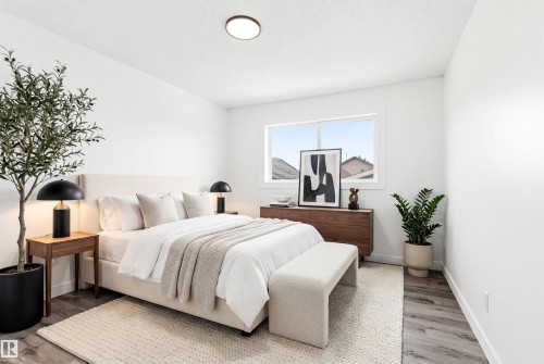 This bedroom features light-colored walls, a window providing natural light, and wood-look flooring - 16223 55A Street, Edmonton, AB - Indoor Photo Showing Bedroom