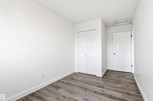The room features light wood-style flooring and white walls, offering a bright and neutral aesthetic - 16223 55A Street, Edmonton, AB - Indoor Photo Showing Other Room