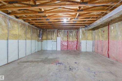 Expansive unfinished space featuring exposed wooden ceiling joists, concrete flooring, and insulated walls - 16223 55A Street, Edmonton, AB - Indoor Photo Showing Basement