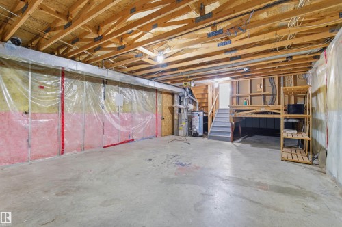The basement features exposed wooden ceiling beams and a concrete floor - 16223 55A Street, Edmonton, AB - Indoor Photo Showing Basement