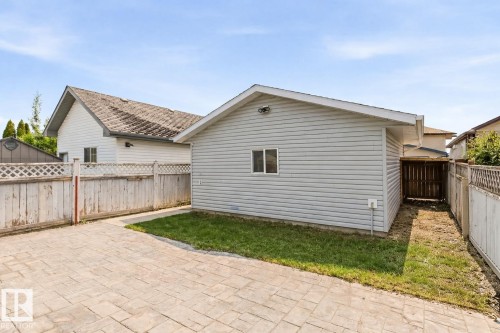 The property features a detached garage with light-colored siding and a window - 16223 55A Street, Edmonton, AB - Outdoor With Exterior