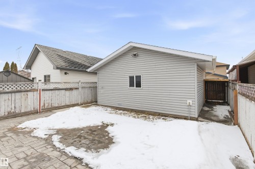 The property features a detached garage with light-colored siding and a window, situated on a paved surface - 16223 55A Street, Edmonton, AB - Outdoor With Exterior