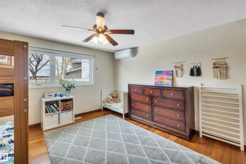 This room features hardwood flooring, light-colored walls, and a window providing natural light - 4208 89 Street Nw, Edmonton, AB - Indoor