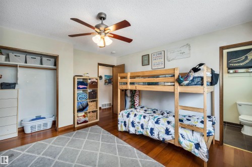 Bedroom featuring hardwood floors, a ceiling fan, and a closet with shelving - 4208 89 Street Nw, Edmonton, AB - Indoor Photo Showing Bedroom