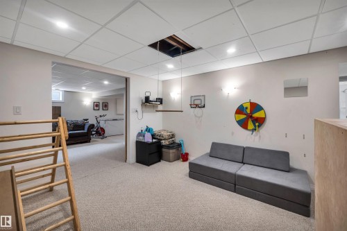 This expansive room features light-colored carpeting, recessed lighting, and a drop ceiling - 4208 89 Street Nw, Edmonton, AB - Indoor