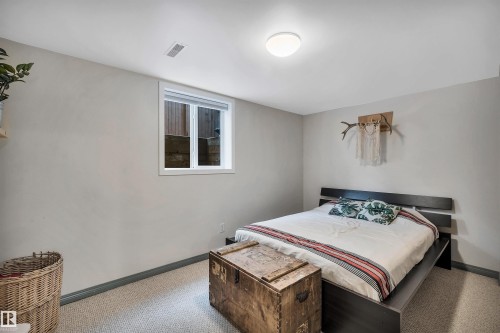This room features light-colored walls and carpeted flooring, creating a neutral base - 4208 89 Street Nw, Edmonton, AB - Indoor Photo Showing Bedroom