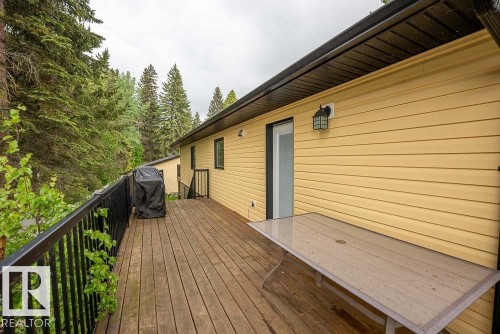 Spacious wood-finish deck with black metal railing - 90 2001 Twp Rd, Rural Leduc County, AB 