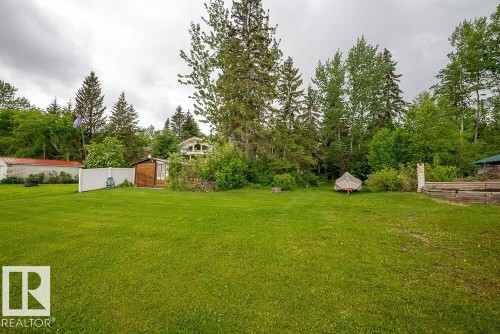 Expansive green space featuring mature trees bordering the property - 90 2001 Twp Rd, Rural Leduc County, AB 