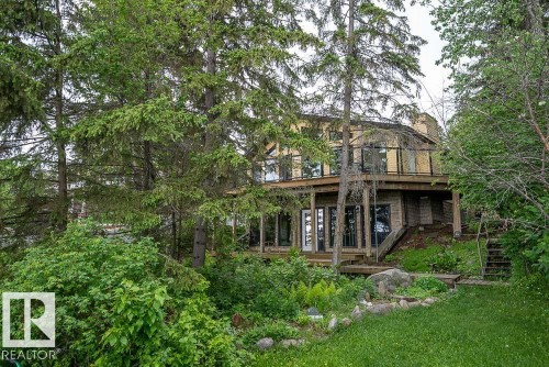 Multi-level residence featuring extensive decking and a natural, wooded setting - 90 2001 Twp Rd, Rural Leduc County, AB 