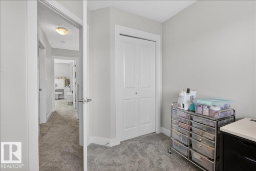 This room features light grey walls and grey carpet flooring - 9034 Rosenthal Link Link, Edmonton, AB - Indoor