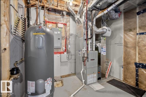 The property features a hot water heater and a furnace - 9034 Rosenthal Link Link, Edmonton, AB - Indoor Photo Showing Basement