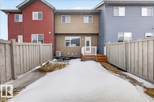 The property features a fenced yard, a wooden deck, and a glass sliding door - 9034 Rosenthal Link Link, Edmonton, AB - Outdoor With Exterior