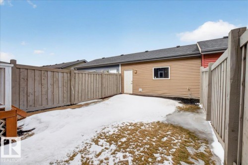 The property features a fenced yard, a rear deck, and a window with trim on the exterior - 9034 Rosenthal Link Link, Edmonton, AB - Outdoor With Exterior
