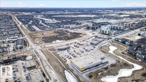 Expansive aerial view showcasing the surrounding community, including residential areas and commercial developments - 9034 Rosenthal Link Link, Edmonton, AB - Outdoor With View