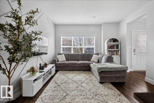 Living area featuring rich dark wood flooring and light-colored walls - 9034 Rosenthal Link Link, Edmonton, AB - Indoor Photo Showing Living Room